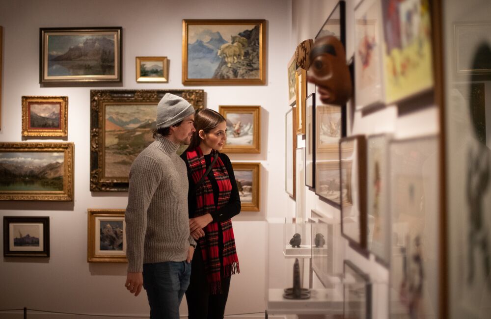 A couple taking in an art exhibit at the Whyte Museum of the Canadian Rockies